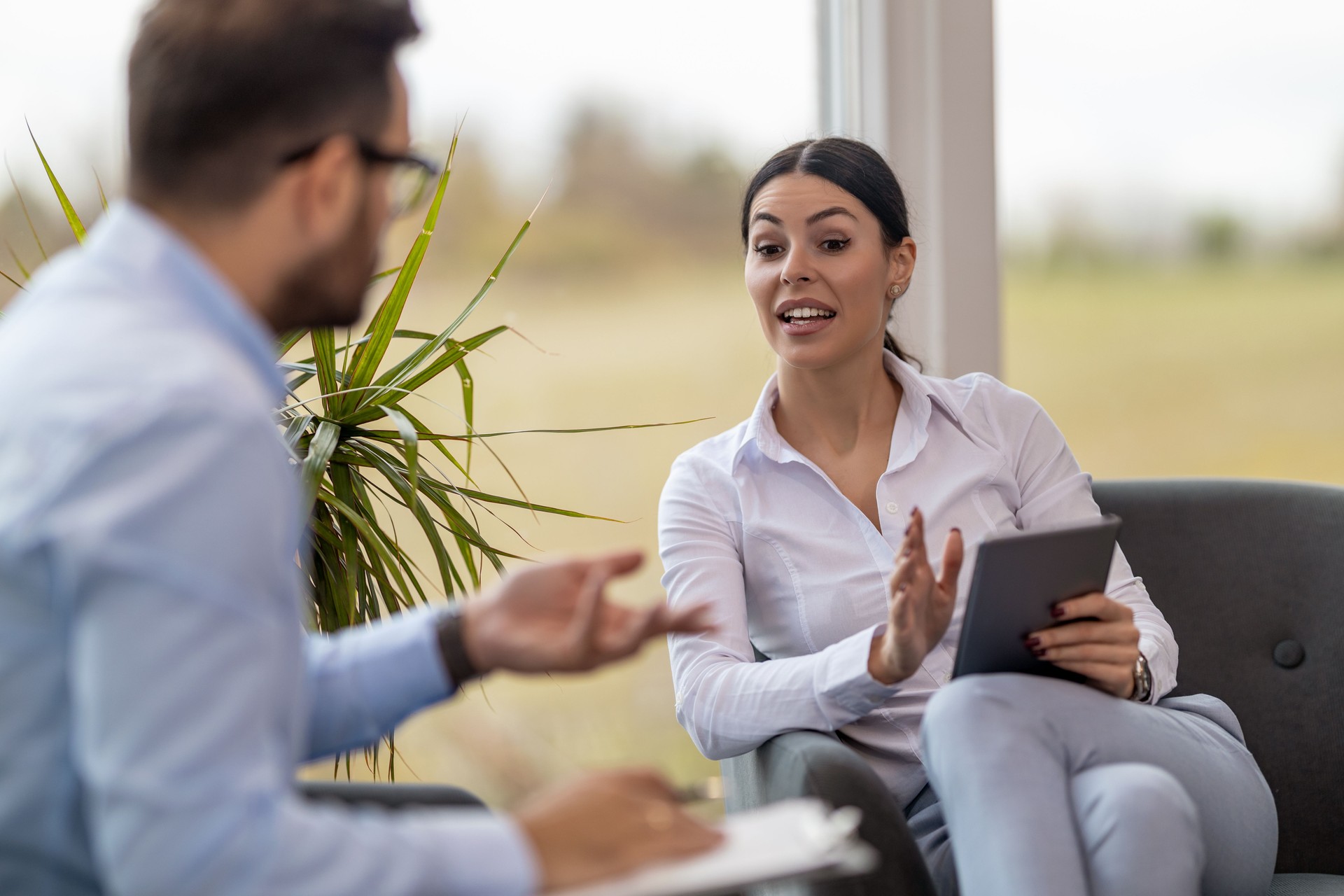 Real estate agent with woman closing a deal and signing a contract